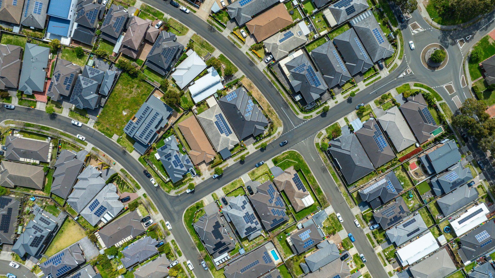 Aerial view of an Australian suburb with rooftop solar panels on many homes
